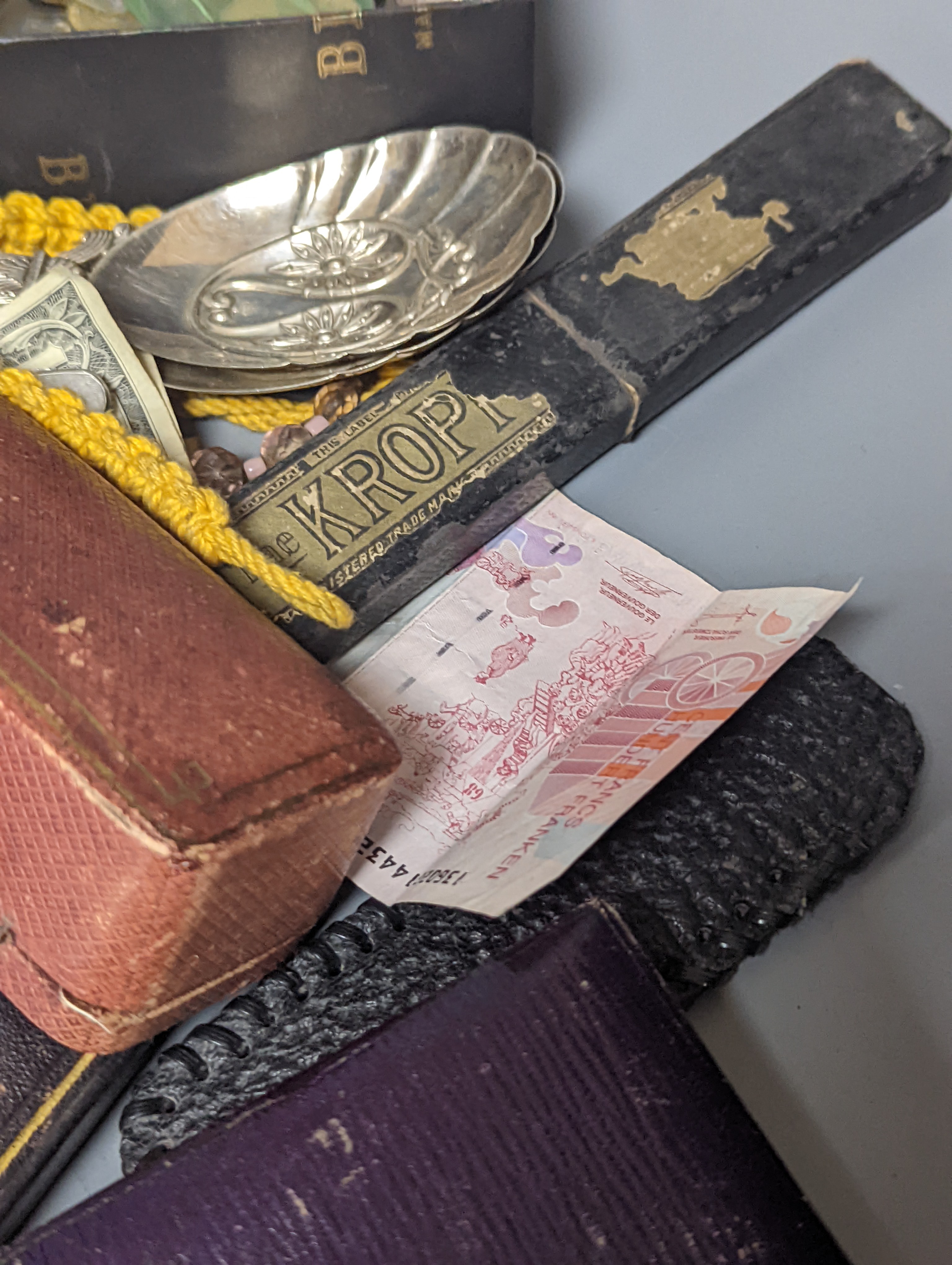 A pair of silver spoons, a small timepiece, assorted coinage and sundries